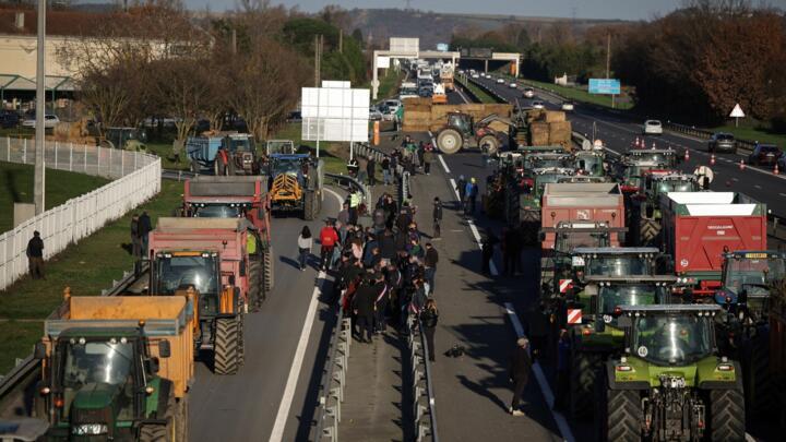 Farmers block part of the A64 motorway, during a demonstration in Carbonne, south-western France, on December 12, 2025