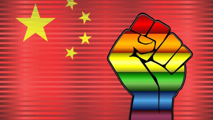 A raised fist bearing the colours of the rainbow against a backdrop of the Chinese flag.