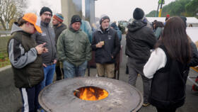 Farmers take part in the blockade of  the A64 motorway to protest the culling of cows due to a skin disease in southwestern France