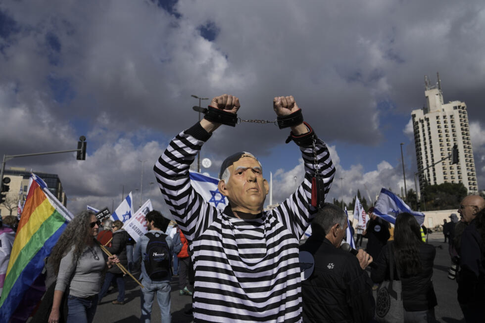 A protester wears a mask depicting Israeli Prime Minister Binyamin Netanyahu in front of the Supreme Court in Jerusalem on January 5, 2023.