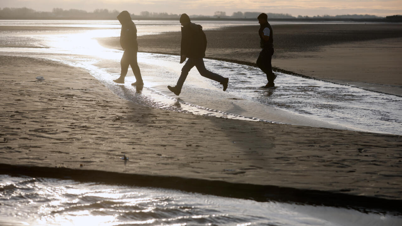 Migrants leave the beach after failing to cross the Channel and reach Britain in Gravelines, northern France.