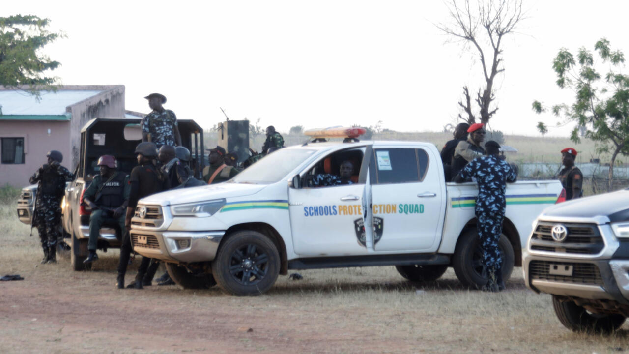 Police officers stand guard outside a school in Nigeria's Kebbi where pupils were kidnapped on November 17, 2025.