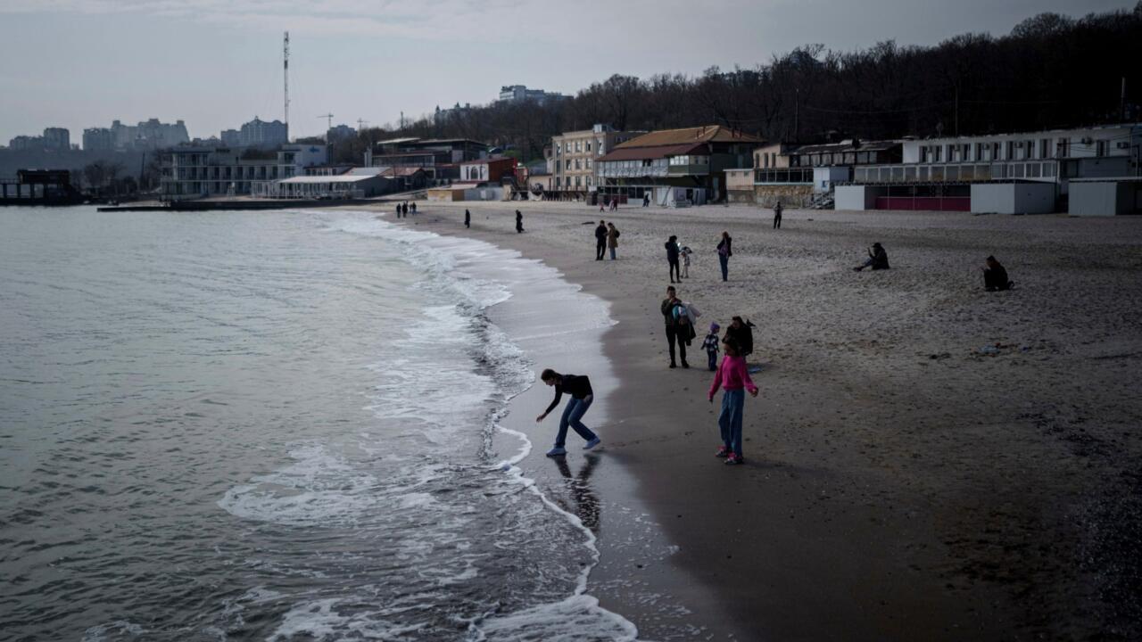 A girl touches the water at Lanzheron beach in Odesa, Ukraine, March 26, 2025.