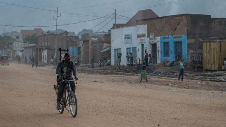 A man rides a bicycle along a street as people return to homes in Uvira Democratic Republic of Congo, Saturday, Dec. 13, 2025.