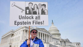 A protesters holds a sign calling for the release of all Epstein files at the Capitol in Washington, on December 18, 2025.