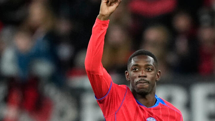 PSG's Ousmane Dembele celebrates after he scored his side's 6th goal during the Champions League opening phase soccer match between Bayer Leverkusen and Paris Saint-Germain in Leverkusen, Germany. 